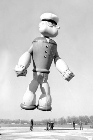 Popeye, a tengerész, parádés léggömb megfeszíti az izmait, miközben repülésre készül